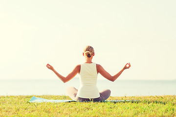 Image showing woman making yoga exercises outdoors