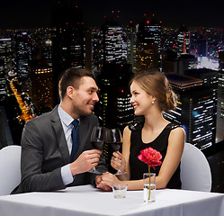 Image showing young couple with glasses of wine at restaurant