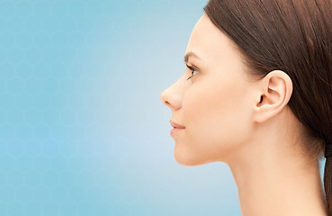 Image showing beautiful young woman face over blue background