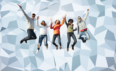 Image showing smiling friends in sunglasses jumping high