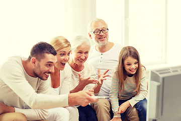 Image showing happy family watching tv at home