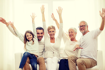 Image showing happy family sitting on sofa at home