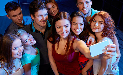 Image showing friends with smartphone taking selfie in club