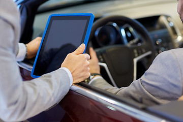 Image showing close up of men with tablet pc in car salon