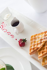 Image showing close up of waffles on plate at breakfast table