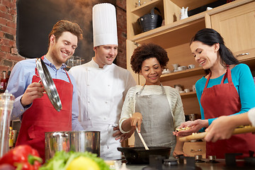 Image showing happy friends and chef cook cooking in kitchen