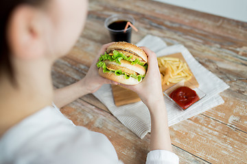 Image showing close up of woman hands holding hamburger