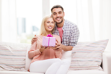 Image showing happy man giving woman gift box at home