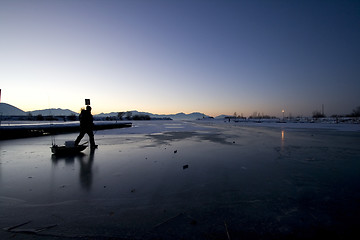 Image showing Fisherman Walking on Ice to Catch Fish