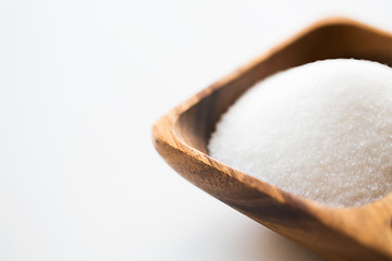 Image showing close up of white sugar heap in wooden bowl