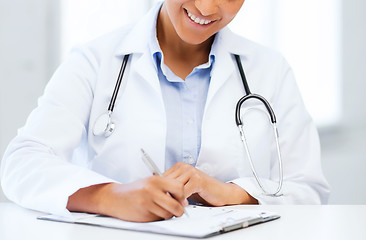 Image showing female doctor writing prescription