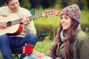 Image showing smiling couple with guitar in camping