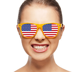 Image showing happy teenage girl in shades with american flag