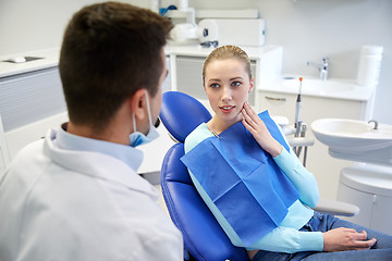 Image showing male dentist with woman patient at clinic