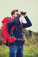 Image showing man with backpack and binocular outdoors