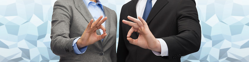 Image showing businessman and businesswoman showing ok sign