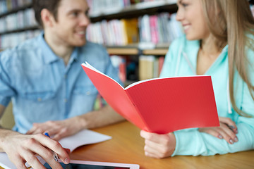 Image showing close up of students with notebooks in library