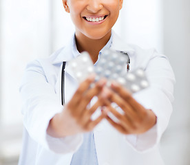 Image showing doctor with blister packs of pills