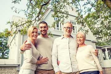 Image showing happy family in front of house outdoors