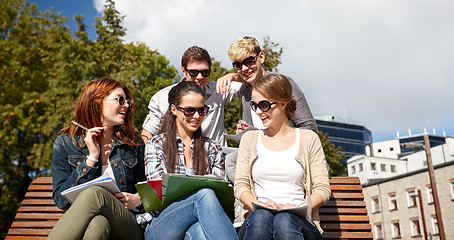 Image showing group of happy students with notebooks at campus