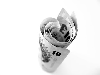 Image showing money rolled on white background