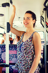 Image showing smiling teenage girl going by bus