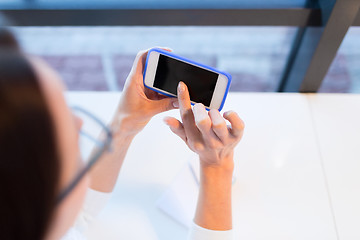 Image showing close up of woman with smartphone at office