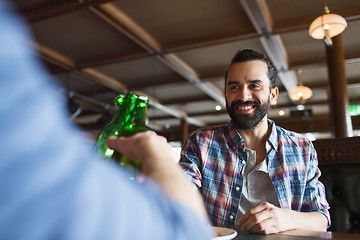 Image showing happy male friends drinking beer at bar or pub