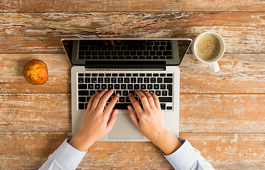 Image showing close up of female hands with laptop and coffee