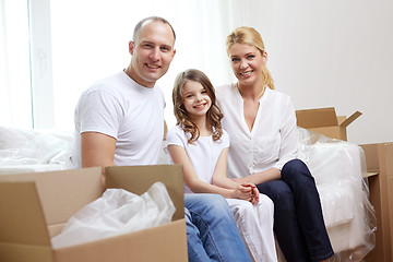 Image showing happy family with boxes moving to new home