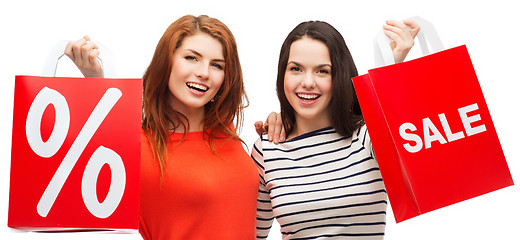 Image showing two smiling teenage girl with shopping bags