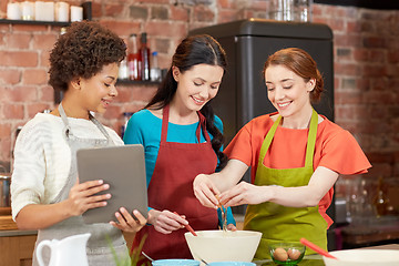 Image showing happy women with tablet pc in kitchen