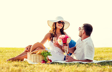 Image showing smiling couple drinking champagne on picnic