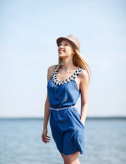 Image showing girl in hat walking on the beach