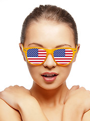 Image showing happy teenage girl in shades with american flag