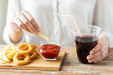 Image showing close up of woman with snacks and cocacola