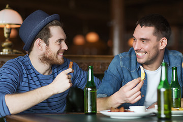 Image showing happy male friends drinking beer at bar or pub