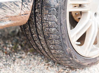 Image showing close up of dirty car wheel on ground