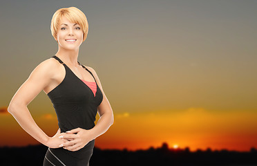 Image showing happy woman outdoors over sunset skyline
