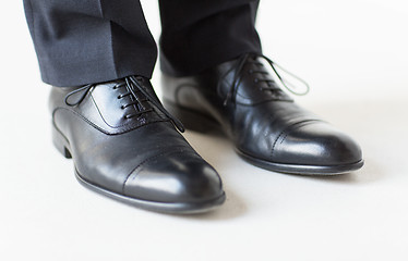 Image showing close up of man legs in elegant shoes with laces