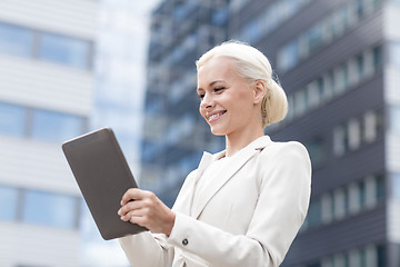 Image showing smiling businesswoman with tablet pc outdoors