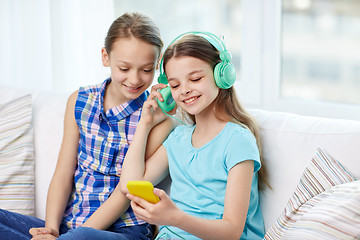 Image showing happy girls with smartphone and headphones