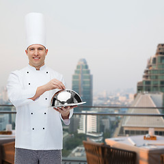 Image showing happy male chef cook holding cloche