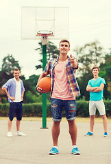 Image showing group of smiling teenagers playing basketball