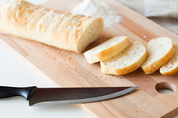 Image showing close up of white bread or baguette and knife