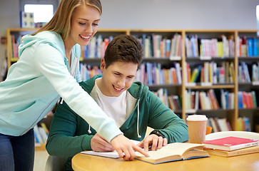 Image showing happy students preparing to exams in library