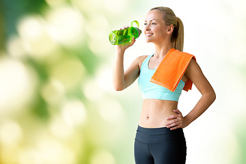 Image showing woman with bottle of water and towel