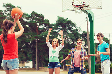 Image showing group of smiling teenagers playing basketball