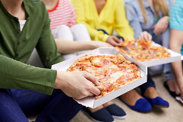 Image showing close up of happy friends eating pizza at home