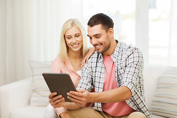 Image showing smiling happy couple with tablet pc at home